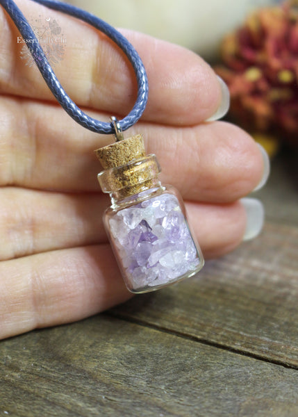 Amethyst Crystal Chip Bottle Necklace - A tiny bottle pendant filled with Amethyst chips, promoting calm and spiritual insight.