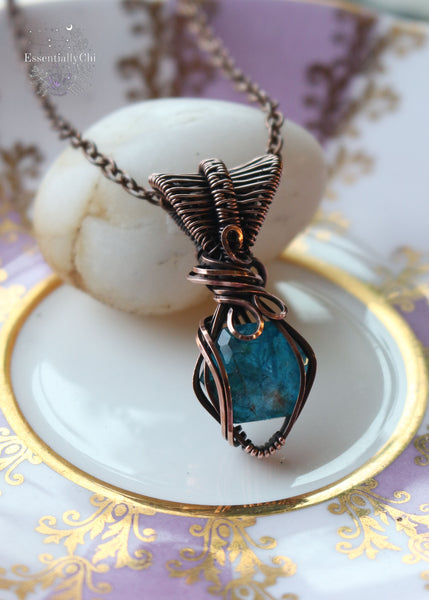 Ice Blue Apatite and Quartz Doublet Copper Wire Wrapped Necklace - A celestial fusion of communication-enhancing Apatite and clarity-amplifying Quartz, uniquely designed for beauty and spiritual benefits. This 1.5" pendant hangs gracefully from an 18" copper chain