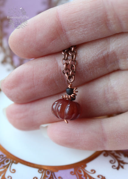 Dainty Dark Red Carnelian Pumpkin Copper Necklace - A petite 14mm carnelian pumpkin pendant suspended from a 21" copper chain, designed to help you always carry the memories of autumn