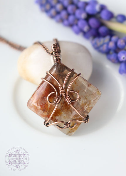 Indulge in the harmonious blend of strength and celestial beauty with our Hematite Garden Quartz Copper Wire Wrapped Necklace. The square-shaped garden quartz, resembling a wrapped package, showcases hematite inclusions, iridescent rainbows, and rutile. This handcrafted masterpiece promotes balance, protection, and a radiant connection to the divine. Perfect for Aries and Aquarius, this unique pendant aligns with the root and crown chakras, making it a symbol of grounding and spiritual elevation.