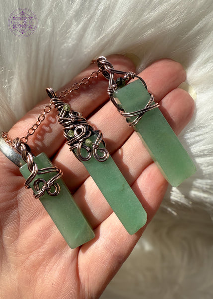 Three green aventurine pendants held in hand, each have simple yet different designs. Part of the Heart Chakra Collection.