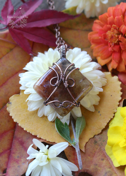 Indulge in the harmonious blend of strength and celestial beauty with our Hematite Garden Quartz Copper Wire Wrapped Necklace. The square-shaped garden quartz, resembling a wrapped package, showcases hematite inclusions, iridescent rainbows, and rutile. This handcrafted masterpiece promotes balance, protection, and a radiant connection to the divine. Perfect for Aries and Aquarius, this unique pendant aligns with the root and crown chakras, making it a symbol of grounding and spiritual elevation.