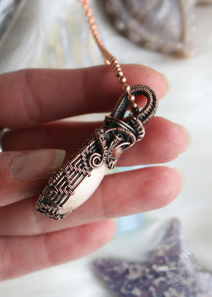 Elevate your spiritual style with our Peach Scolecite Copper Wire Wrapped Necklace. Delicately woven copper embraces a teardrop-shaped peach scolecite, accompanied by a pink jasper in the bail. This handcrafted masterpiece exudes calming energy, promoting emotional healing and spiritual upliftment. Perfect for Libra & Capricorn zodiacs, this necklace aligns with the crown and third eye chakras, fostering a sense of tranquility and connecting you to the divine feminine energy.