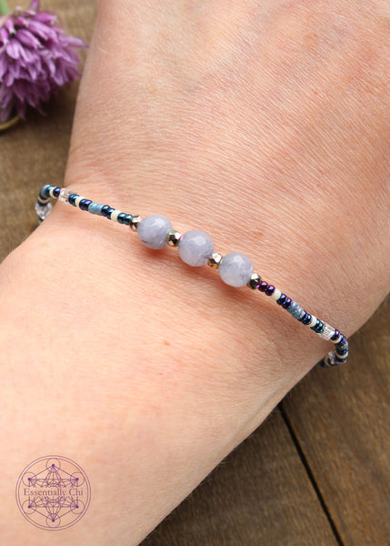Beaded Stretchy Boho Stacker Bracelets. Faceted Dyed light blue quartz 6mm beads with dark blue, light blue, white, and silver seed beads.