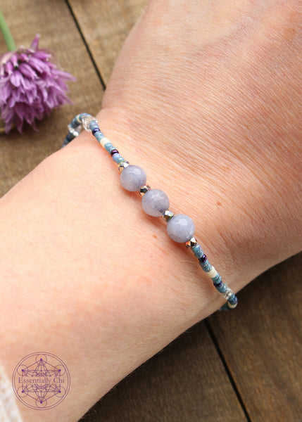 Beaded Stretchy Boho Stacker Bracelets. Faceted Dyed light blue quartz 6mm beads with light blue, dark blue, white, and silver seed beads.