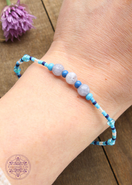 Beaded Stretchy Boho Stacker Bracelets. Faceted Dyed light blue quartz 6mm beads with light blue, navy blue, opalescent, and silver seed beads.