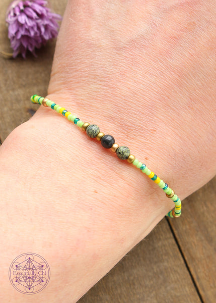 Beaded Stretchy Boho Stacker Bracelets. serpentine 4mm beads with lime green, emerald colored, yellow and brass seed beads.