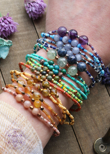Beaded Stretchy Boho Stacker Bracelets all on the wrist to show available colors. Shown with my wrist on the table to display how loose each one is on the wrist.