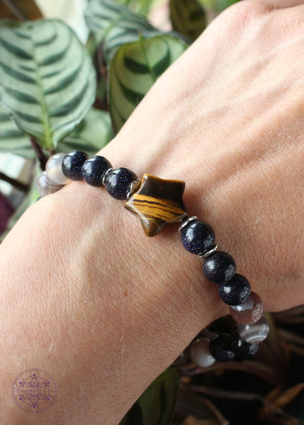 Shimmery and sparkly crystal stretch bracelet with a star shaped tiger eye focal bead, 8mm blue goldstone, and grey Botswana agate beads.