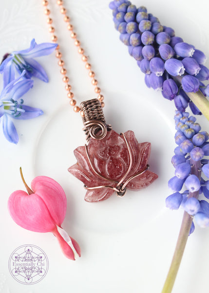 Tanzberry Lotus Copper Wire Wrapped Necklace featuring a carved lotus tanzberry that is very sparkly (red aventurine) crystal, wrapped in a simple copper wire that flows with the petals of the lotus. Pendant is 1.5" long on an 18" copper chain. Enhances determination, perseverance, and spiritual awakening.