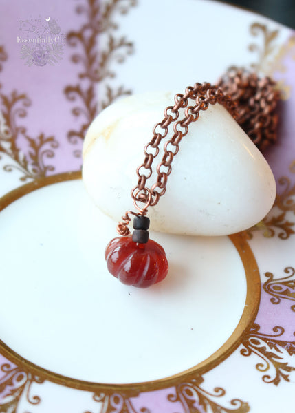 Dainty Dark Red Carnelian Pumpkin Copper Necklace - A petite 14mm carnelian pumpkin pendant suspended from a 21" copper chain, designed to help you always carry the memories of autumn