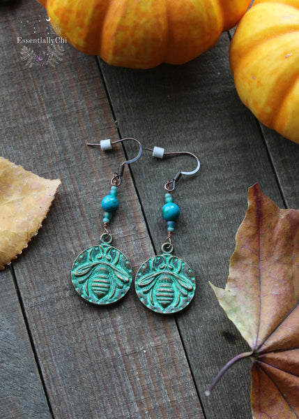 Chrysocolla Copper Bee Earrings, 2.25 inches in length with Chrysocolla beads and a green antiqued copper bee charm. Perfect for nature lovers and beekeepers, these earrings feature copper ear hooks for an earthy, elegant touch.