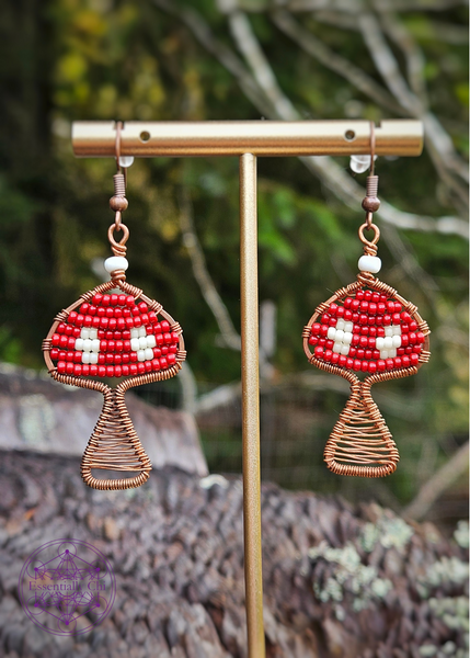 Copper Wire Wrapped mushroom earrings with a red and white beaded Amanita mushroom design. Dangle earrings on brass ear wires. 