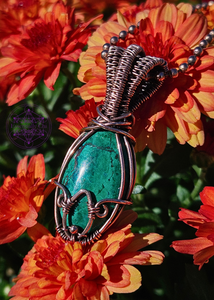 Chrysocolla in Bloom necklace in wire wrapped copper. Crystal is an oval shape with a copper wrapped petal shape at the bottom. Bail is an elegant layered look for depth. 