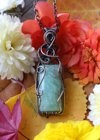 Flora pendant, a Chrysoprase copper wire-wrapped jewelry piece with an elegantly wrapped filigree design. Chrysoprase centerpiece symbolizing growth and renewal, inspired by the goddess Flora of spring and flowers.