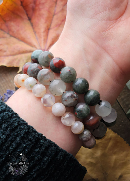 A collection of Chunky Grounding Stretch Bracelets crafted with Flower Agate, Wood Beads, and African Bloodstone. Each bracelet is designed to harness the grounding energy of nature, promoting stability and resilience.
