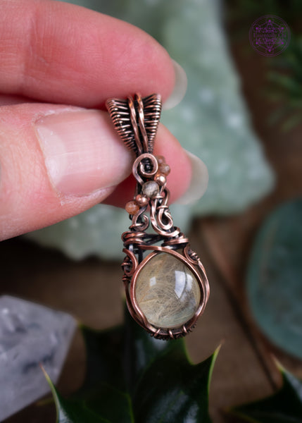 This copper wire wrapped pendant has a small round golden rutile crystal and accent crystal beads of sunstone and citrine that catch the light and really make this pendant sparkle like stardust! Shown in hand for size reference.