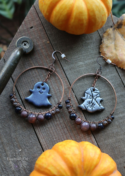 Ghostly Beaded Hoop Earrings featuring polymer clay ghost charms with a spooky-cute spider web design. Adorned with Botswana Agate, Rhodonite, and Blue Goldstone beads. Hoops measure 1.75 inches in diameter, with a total length of 3 inches. Perfect for a bewitching and whimsical look