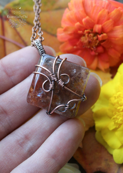 Indulge in the harmonious blend of strength and celestial beauty with our Hematite Garden Quartz Copper Wire Wrapped Necklace. The square-shaped garden quartz, resembling a wrapped package, showcases hematite inclusions, iridescent rainbows, and rutile. This handcrafted masterpiece promotes balance, protection, and a radiant connection to the divine. Perfect for Aries and Aquarius, this unique pendant aligns with the root and crown chakras, making it a symbol of grounding and spiritual elevation.