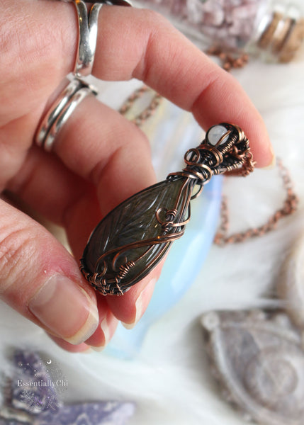 Leaf-etched Blue Flash Labradorite pendant with Rainbow Moonstone accent on a 20" copper chain – a nature-inspired masterpiece with mystical charm.
