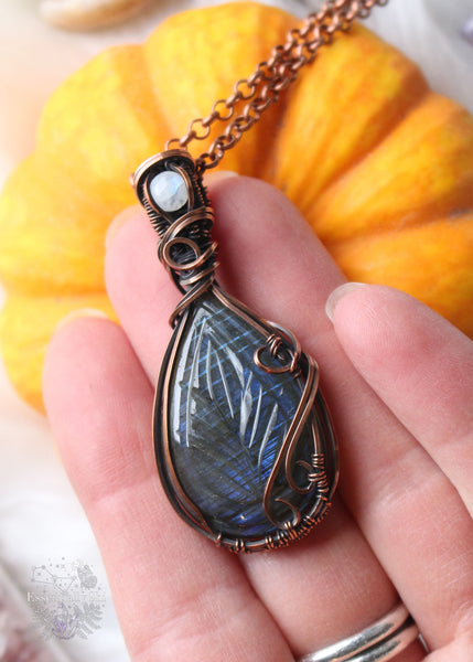 Leaf-etched Blue Flash Labradorite pendant with Rainbow Moonstone accent on a 20" copper chain – a nature-inspired masterpiece with mystical charm.