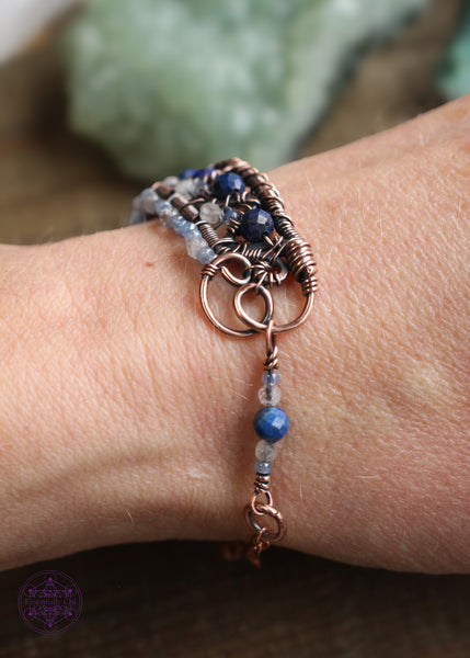 Detail of the side of the bracelet shown worn on wrist with the billowy loop side where the extra beaded detail connects.