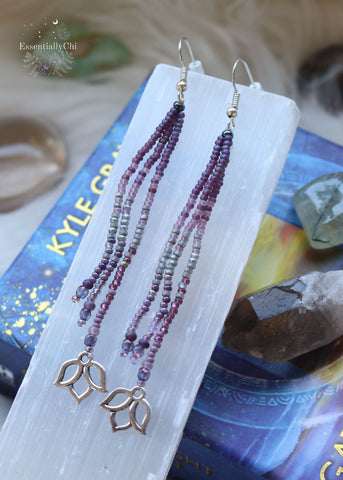 Graceful 4-inch Purple Lotus Tassel Beaded Earrings with a silver-colored lotus charm, featuring a vibrant purple gradient pattern. Lightweight and symbolic, these earrings bring a touch of zen to your look. Stainless steel earring hooks ensure durability and sophistication.