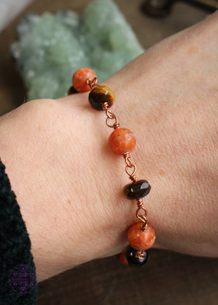Copper wire wrapped bracelet features 8mm Orchid Calcite beads individually wrapped with faceted rondelle Tiger Eye beads individually wrapped linking together for an elegant bracelet. Shown on wrist to see how it lays. 