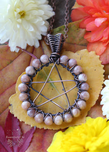 Peach Moonstone Pentacle Necklace - A mystical and bewitching pendant featuring a Peach Moonstone crystal with pentacle symbol and copper wire wrapping. Perfect for witches and Halloween enthusiasts. Enhance intuition, emotional healing, and embrace divine feminine energy with this magical jewelry. Peach moonstone beads line the outside of the circle of the pentacle design and are secured with copper wire crisscross pattern.