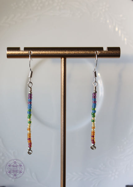 Pride Rainbow Earrings with seed bead drop design in rainbow pattern of purple to red on silver plated wire hanging 2.25" from silver toned ear wires.