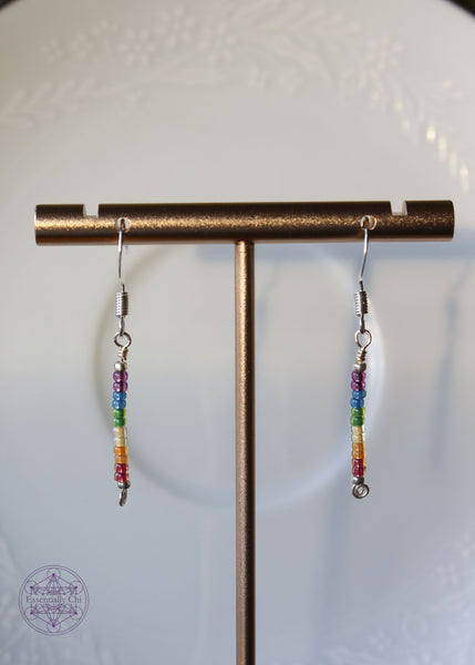 Pride Rainbow Earrings with seed bead drop design in rainbow pattern of purple to red on silver plated wire hanging 1.75" from silver toned ear wires.