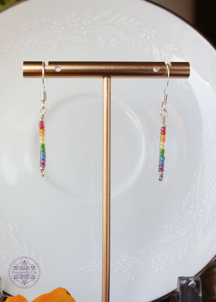 Pride Rainbow Earrings with seed bead drop design in rainbow pattern of red to purple on silver plated wire hanging 1.75" from silver toned ear wires.