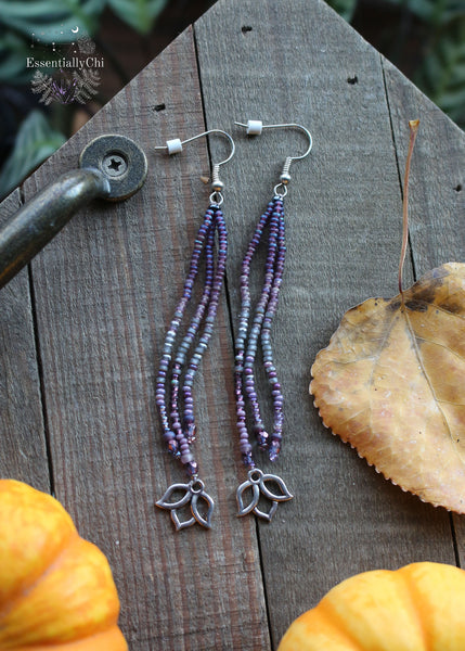 Graceful 4-inch Purple Lotus Tassel Beaded Earrings with a silver-colored lotus charm, featuring a vibrant purple gradient pattern. Lightweight and symbolic, these earrings bring a touch of zen to your look. Stainless steel earring hooks ensure durability and sophistication