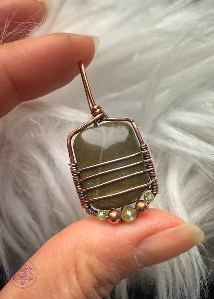 Bottom pendant variation is a light olive green stone with accent beads of copper, light green tourmaline, and peridot along the base and four lines of copper along the bottom half of the pendant for security and design. 