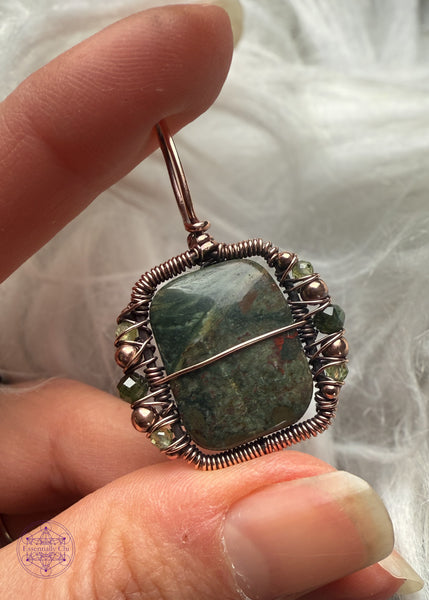 Side pendant variation is a dark green stone with some red spots. Accent beads of copper, dark green tourmaline, and peridot along the sides and one line of copper along the middle of the pendant for security and design. 