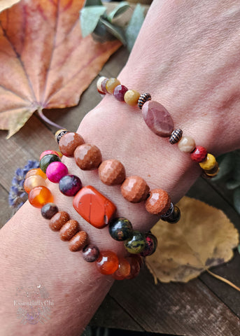 A collection of Sacral Chakra Healing Stretch Bracelets crafted with powerful crystals including Carnelian, Jasper, Goldstone, Chili Jasper, Red Jasper, Tiger Eye, and Mookaite. Each bracelet is designed to stimulate and harmonize the sacral chakra, fostering vitality and emotional balance.