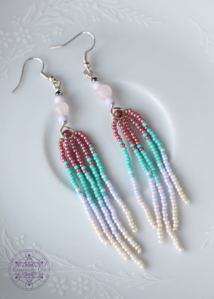 Rose Quartz and Pink Tourmaline Fringe Earrings, 3.5" long with genuine rose quartz and pink tourmaline beads, featuring a graduated mauve to aqua to white to pearl colored seed bead fringe design. show laying down