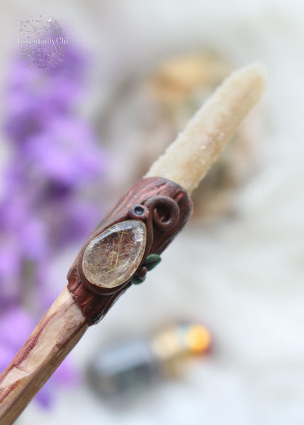 Unveil the enchantment of simplicity with our artisan-carved crystal wand. Crafted from cherry plum wood, adorned with polymer clay tree bark and leaves. Embrace the elegance of a teardrop rutilated quartz and spirit quartz tip. Classic Harry Potter style meets woodland magic in this timeless wand. #ArtisanCrystalWand #WoodlandEnchantment crystal wands for energy work. polymer clay crystal wand, wizzard wand, cosplay magical wand, polymer clay wand, crystal magic. 