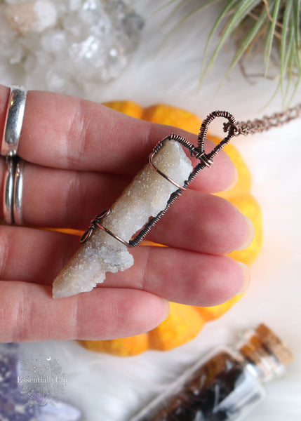 Artemis pendant, a Spirit Quartz copper wire-wrapped jewelry piece with golden hematite inclusions. Simple yet elegant design symbolizing protection and spiritual guidance, inspired by the goddess Artemis of the hunt and wilderness.