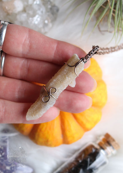 Artemis pendant, a Spirit Quartz copper wire-wrapped jewelry piece with golden hematite inclusions. Simple yet elegant design symbolizing protection and spiritual guidance, inspired by the goddess Artemis of the hunt and wilderness.