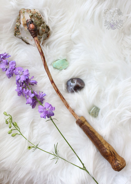 Elevate your energy with our handcrafted crystal wand, a fusion of Sunstone's radiant warmth & Lemurian Quartz's enlightening clarity. Infused with intention & artistry, this wand invites transformation & empowerment into your journey. Crafted from our cherry plum tree, this wand showcases a woodland-inspired polymer clay tip adorned with crystals. The handcarved handle ensures a comfortable grip. Unveil the magic within & wield your own enchanted wand, reminiscent of Harry Potter's world.