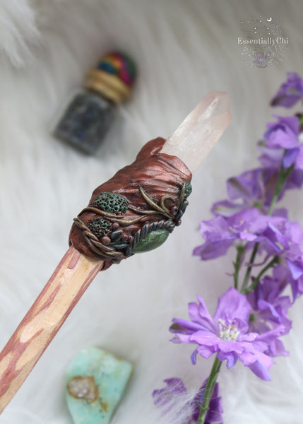 Dive into the realm of woodland enchantment with our handmade crystal wand, adorned with sculpted polymer clay vines and moss, echoing the mystical forest. Embellished with Brazilian tangerine quartz, garnet, and jade crystals, it resonates with vitality, passion, & serenity. A rainbow moonstone at the base of the handle adds a touch of moonlit magic. Elevate your cosplay, energy work, & crystal grids with this versatile wand that enchants any space. #CrystalWand #CrystalMagic Harry potter wand