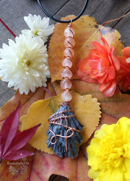 Copper Wire Wrapped Black Kyanite Witches Broom Necklace with Orange Selenite - A bewitching and intricate pendant featuring a spider web design on the Black Kyanite bottom and an Orange Selenite handle. Perfect for Halloween or everyday wear, symbolizing grounding, protection, and metaphysical magic.